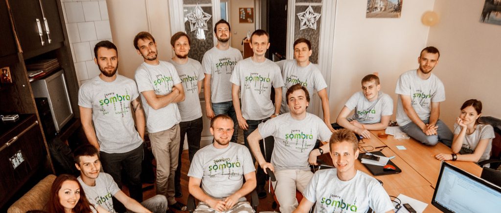Sombra’s growing team between 2016 and 2019, gathered in the office wearing branded company t-shirts.