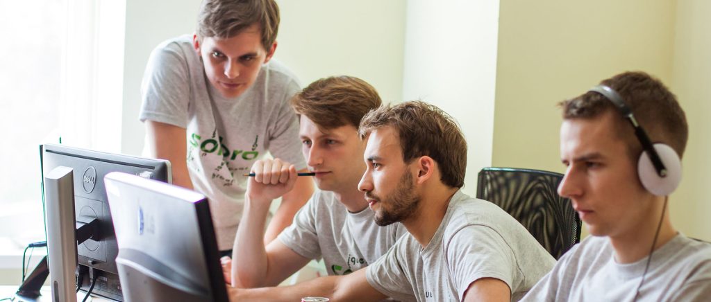 Sombra team members in discussion during the 2020–2024 phase of digital transformation and remote growth.
