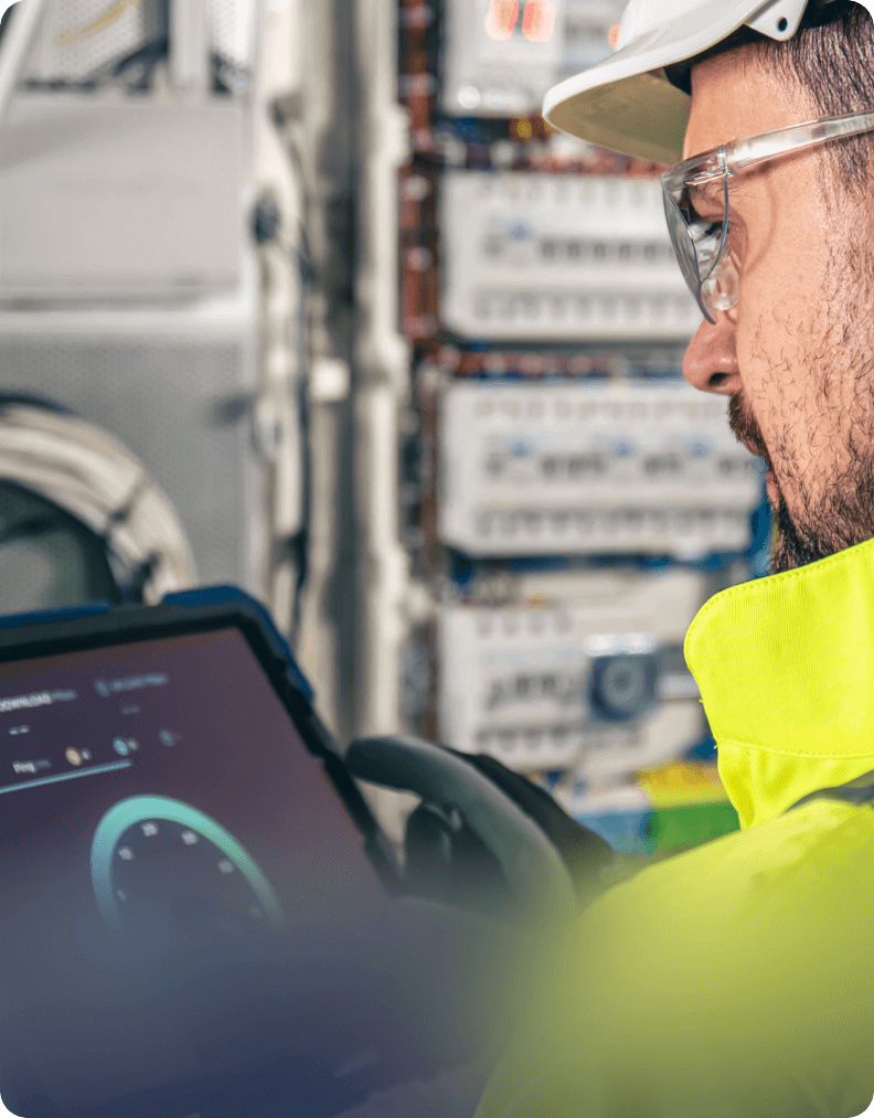 Logistics professional using a tablet to monitor fleet and operational systems inside a vehicle.