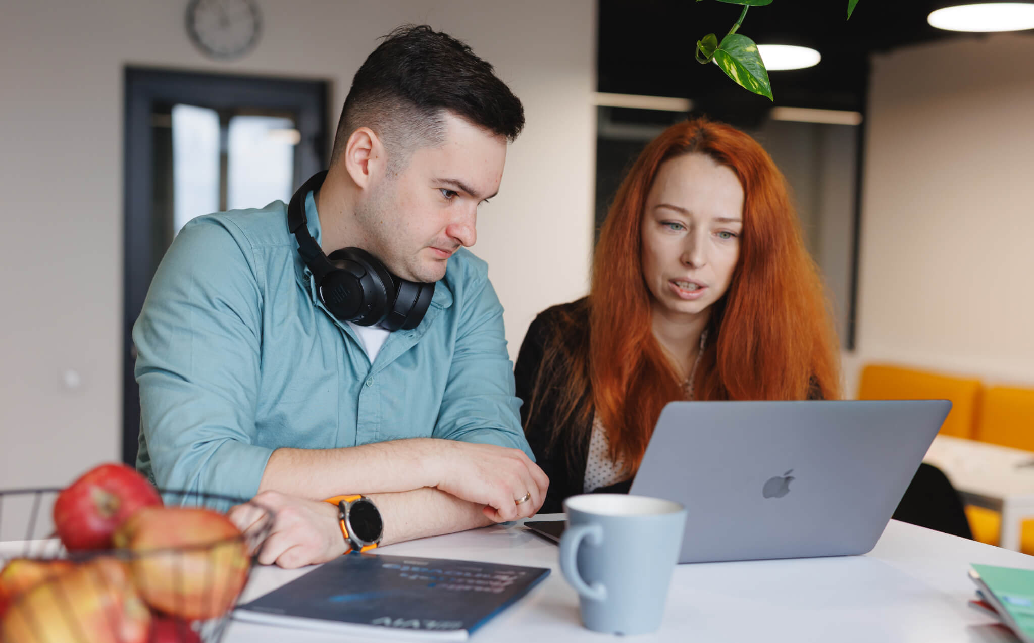 Two Sombra team members collaborating on a project, showcasing the company value of "Action" in 2025.